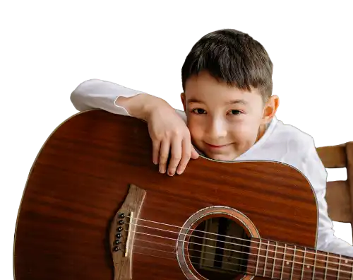 Child posing sweetly with an acoustic guitar