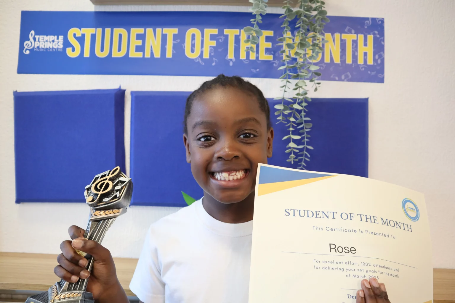 Picture of a student receiving their student of the month certificate. We recognise student excellence at our music tuition centre in Grays.
