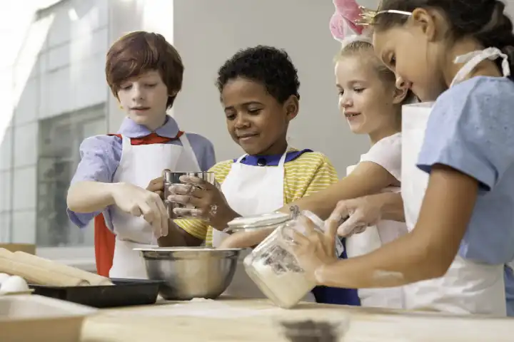 An image of children cooking as part of a holiday club.
